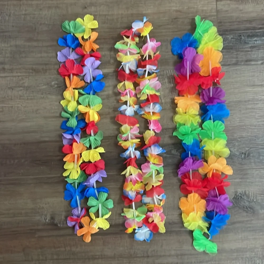 3 multicolored flower leis with two bracelets